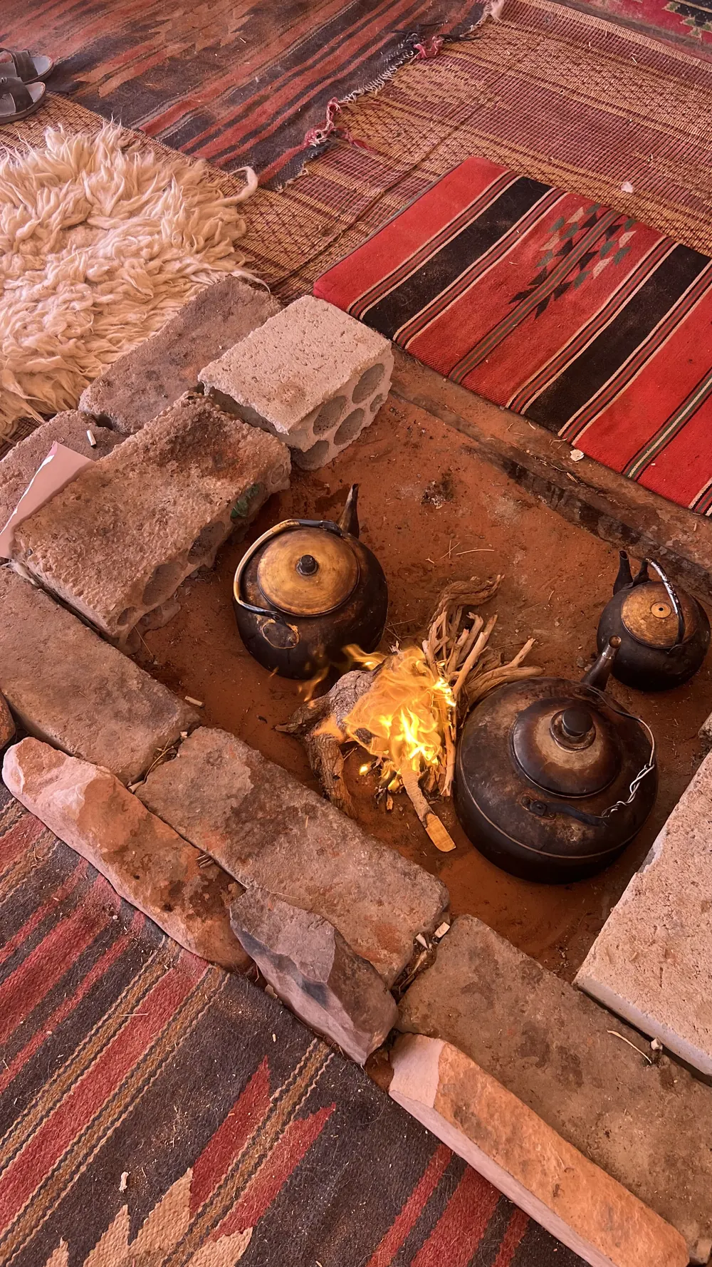 Teapots on the embers inside the Bedouin tent